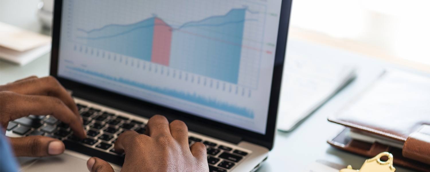 Marketer working on a trend-line graph at his desk